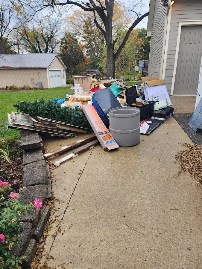 Dumpster being loaded with debris for Estate Cleanout Dumpster Rental in Campton Hills
